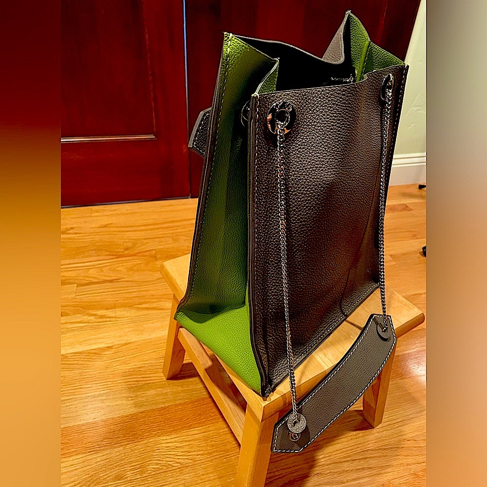 Gray bag with brilliant green accents and silver chain to gray and green handles